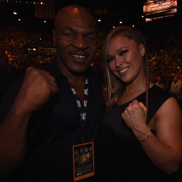 Former UFC women's bantamweight champion Ronda Rousey poses for a photo with former boxing heavyweight champion Mike Tyson at UFC 187.