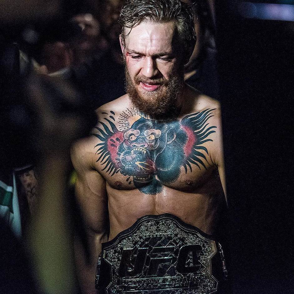 Conor McGregor makes his walk to the back after capturing the UFC interim featherweight title against Chad Mendes at UFC 189